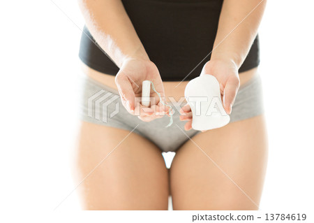 young woman holding hygiene pad and tampon 13784619