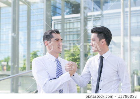 Successful and motivated businessmen are shaking hands 13786858
