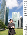 Asian business man standing with cityscape behind 13786901