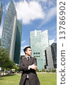 Asian business man standing with cityscape behind 13786902
