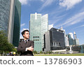Asian business man standing with cityscape behind 13786903
