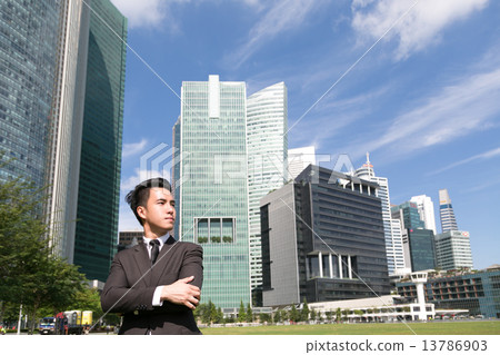 Asian business man standing with cityscape behind 13786903