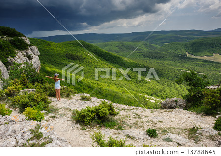Young woman against the storm Young woman against the storm 13788645