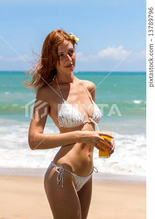 Young woman in bikini with cocktail 13789796