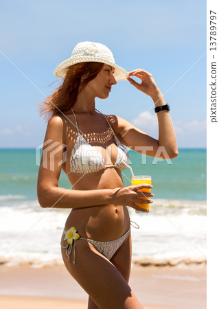 Young woman in bikini with cocktail Young woman in bikini with cocktail 13789797