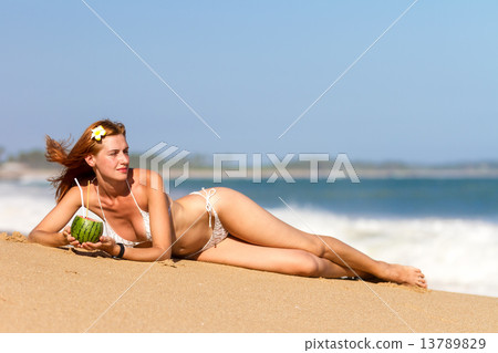 Young woman in bikini with cocktail Young woman in bikini with cocktail 13789829