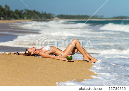 Young woman in bikini with cocktail 13789833