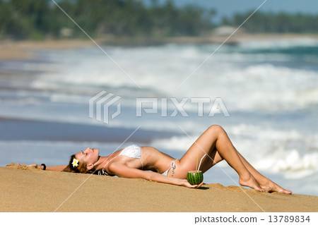 Young woman in bikini with cocktail 13789834