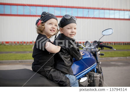 little bikers on road with motorcycle 13794514