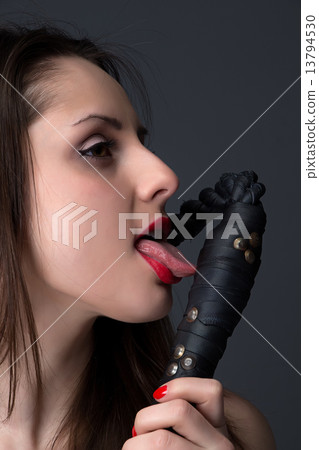 Portrait of the brunette licking a whip 13794530