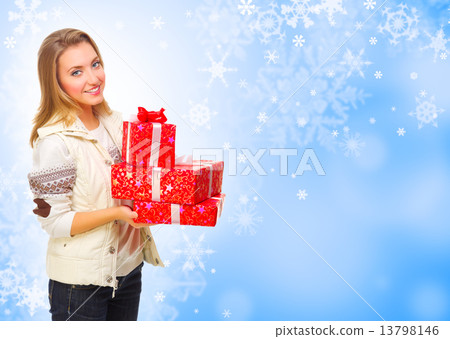 Young girl with gift boxes on winter background Young girl with gift boxes on winter background 13798146