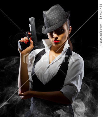 Dangerous and beautiful criminal girl with gun 13798213