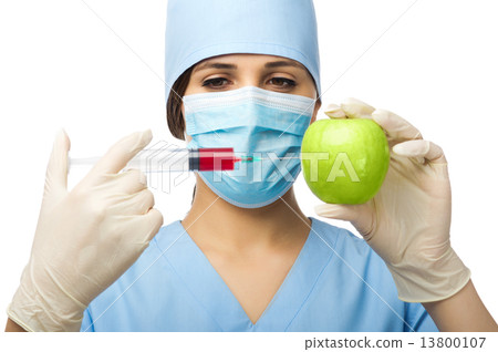 Doctor with syringe and apple 13800107