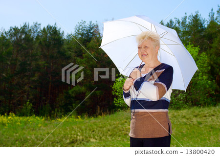 Senior woman with parasol 13800420