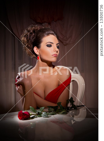 Young woman with rose flower sit on chair Young woman with rose flower sit on chair 13800736