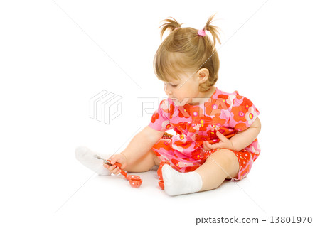 Small baby in red dress with toy cup and spoon 13801970