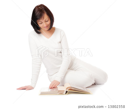Young smiling woman looking album 13802358