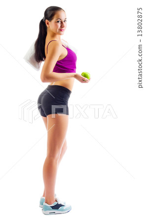 Young sporty woman with towel and apple 13802875