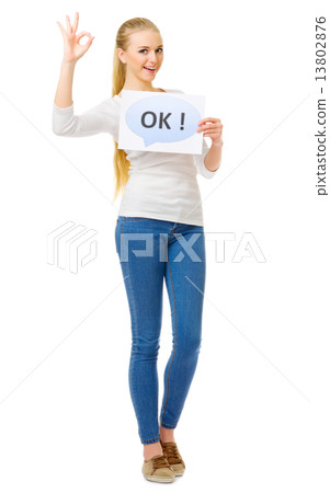 Young girl in blue jeans with "Ok" placard 13802876