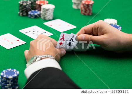 poker player with cards and chips at casino poker player with cards and chips at casino 13805151