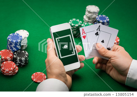 casino player with cards, smartphone and chips casino player with cards, smartphone and chips 13805154