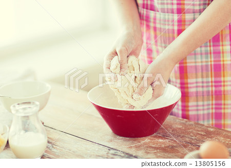 close up of female hands kneading dough at home close up of female hands kneading dough at home 13805156