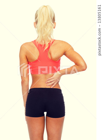 sporty woman touching her back sporty woman touching her back 13805161