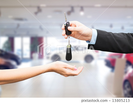 close up of customer and salesman with car key 13805213