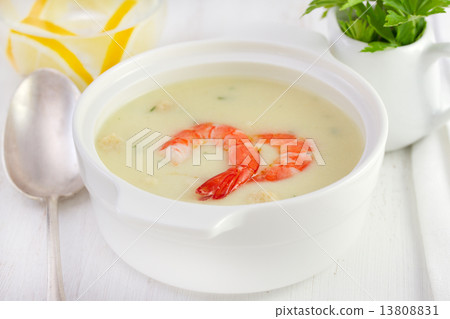soup with seafood in the white bowl with spoon 13808831
