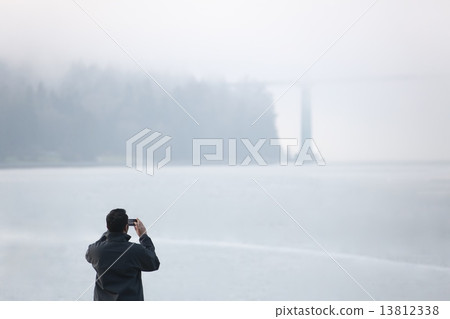 People & Lions Gate Bridge with Fog with people in the fog and Lions gate bridge 13812338