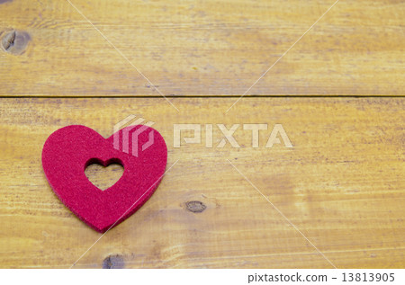 Red heart on a wooden table 13813905