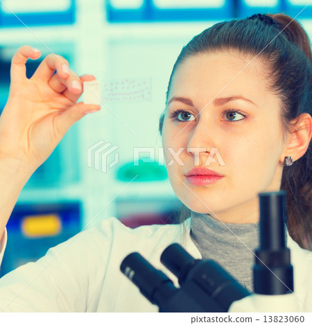 Girl with a slide for the microscope University Hospital 13823060