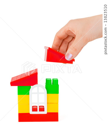 Hand and toy house 13823510