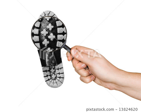 Magnifying glass in hand and shoe printout Magnifying glass in hand and shoe printout 13824620