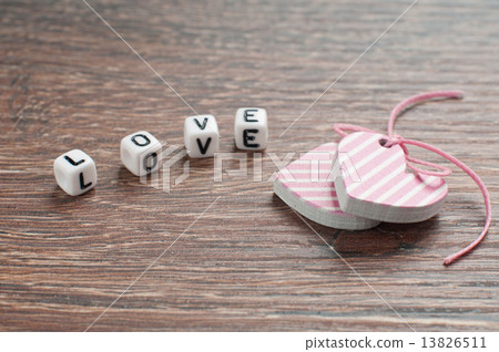pink hearts on wooden board with letters love 13826511