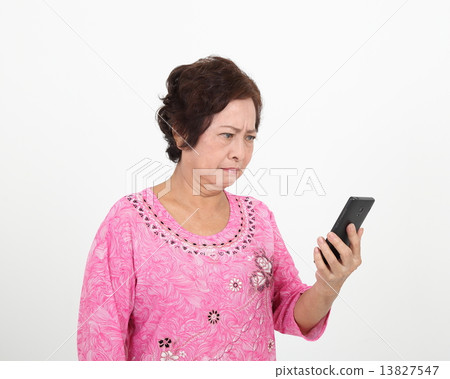 Senior elderly woman reading sms unclear  13827547