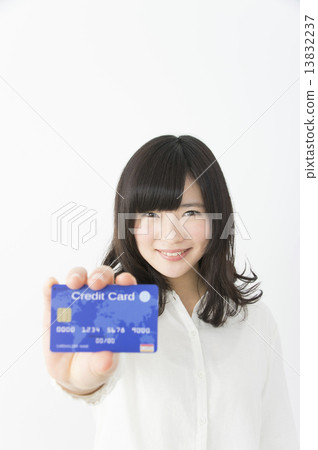 A woman holding a credit card 13832237