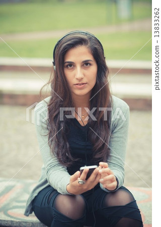 young beautiful brunette woman listening music with headphones 13833262