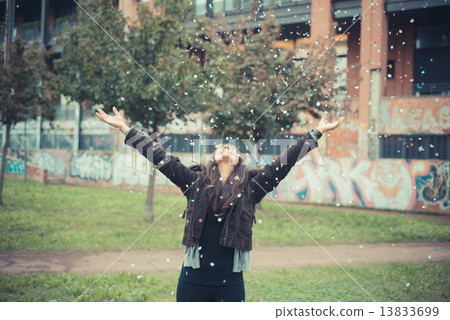 young beautiful brunette woman playing with confetti carnival 13833699