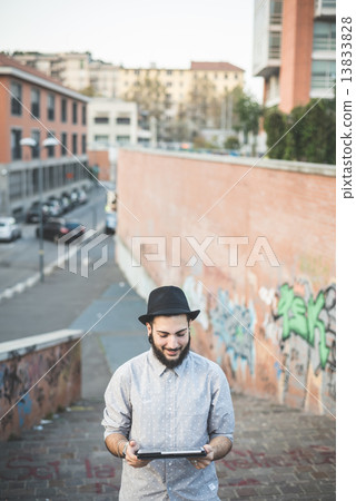 young handsome hipster gay modern man using tablet 13833828