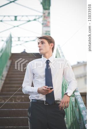 young handsome elegant blonde model man using smartphone 13833938