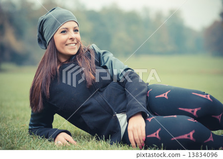 young beautiful brunette straight hair woman in the park 13834096