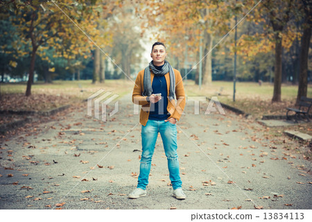 young handsome caucasian man in autumn park 13834113