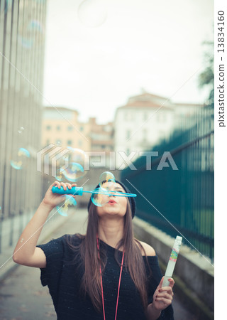 young beautiful brunette woman girl blowing bubbles soup 13834160