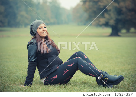 young beautiful brunette straight hair woman in the park 13834357