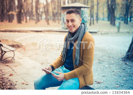 young handsome caucasian man in autumn park 13834364