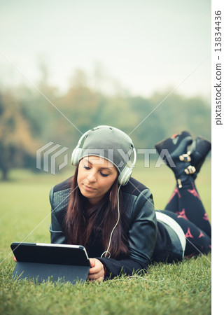young beautiful brunette straight hair woman in the park 13834436