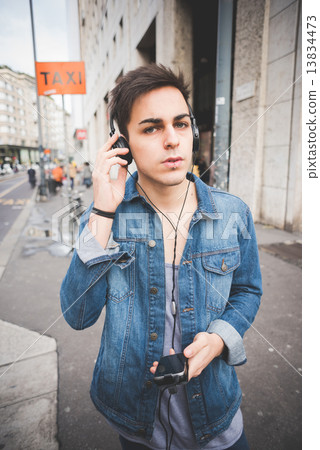 young handsome alternative dark model man in town listening to m 13834473