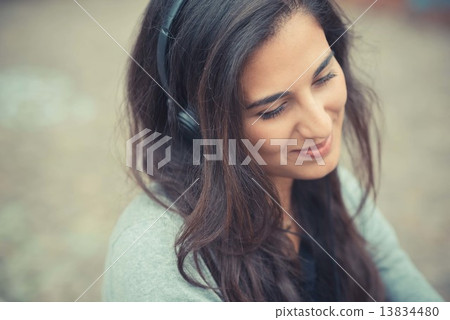 young beautiful brunette woman listening music with headphones 13834480