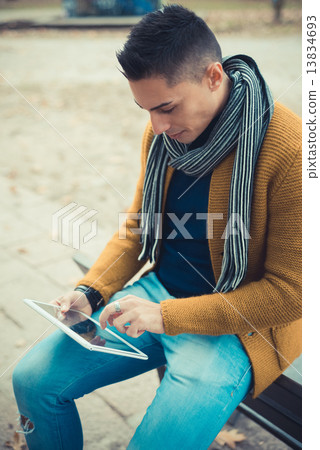 young handsome caucasian man in autumn park 13834693
